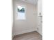 Bright laundry room with a window, storage cabinet and gray vinyl flooring at 150 Doris Path, Dallas, GA 30157