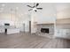 Open-concept living room with fireplace, kitchen, and hardwood floors at 150 Doris Path, Dallas, GA 30157