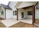 Covered patio with wood ceiling, dark stained posts and an outdoor living space at 150 Doris Path, Dallas, GA 30157