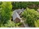 Aerial view of home with mature trees and a classic roof design nestled in a serene, lush neighborhood at 4825 Brighton Lake Dr, Cumming, GA 30040