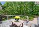 Open back deck overlooking a beautifully landscaped yard, creating a serene outdoor space with a table and chairs at 4825 Brighton Lake Dr, Cumming, GA 30040