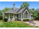 Back exterior with large windows, grey siding, brick patio, and meticulously maintained landscaping at 4825 Brighton Lake Dr, Cumming, GA 30040