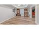 Finished basement boasting wood-look flooring, recessed lighting, and built-in bookshelves for versatile living space at 4825 Brighton Lake Dr, Cumming, GA 30040