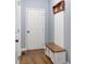 Inviting entryway features a wooden storage bench, coat rack, and hardwood floors for added convenience and style at 4825 Brighton Lake Dr, Cumming, GA 30040