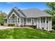 Back of the house showing spacious backyard with large windows and the outdoor deck and patio space at 4825 Brighton Lake Dr, Cumming, GA 30040