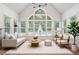 Bright living room boasts large arched windows, contemporary lighting, and stylish furniture for a relaxing atmosphere at 4825 Brighton Lake Dr, Cumming, GA 30040