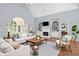Bright living room with hardwood floors, vaulted ceilings, built-in shelves, and comfortable seating at 4825 Brighton Lake Dr, Cumming, GA 30040