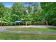 Outdoor recreation area featuring a volleyball court, picnic shelter, and lush green surroundings, great for community enjoyment at 4825 Brighton Lake Dr, Cumming, GA 30040