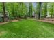 Expansive green backyard, surrounded by trees, offering privacy and space at 3157 Sawyer Ne Ct, Marietta, GA 30066
