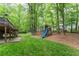 Large backyard features a spacious deck and a wooden swing set with a blue slide at 3157 Sawyer Ne Ct, Marietta, GA 30066