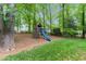Beautiful backyard features a wooden swing set with a blue slide, perfect for children at 3157 Sawyer Ne Ct, Marietta, GA 30066