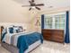 Cozy bedroom with a plush bed, hardwood dresser, and a bright window at 3157 Sawyer Ne Ct, Marietta, GA 30066