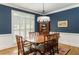 Traditional dining room with navy blue walls, white trim and a wooden table that seats six at 3157 Sawyer Ne Ct, Marietta, GA 30066