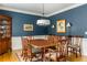 Traditional dining room with navy blue walls, white trim and a wooden table that seats six at 3157 Sawyer Ne Ct, Marietta, GA 30066