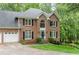 Elegant two-story brick home featuring a manicured lawn, black shutters and a two car garage at 3157 Sawyer Ne Ct, Marietta, GA 30066