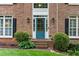 Close up of the front entrance with an arched window, bright blue door and manicured landscaping at 3157 Sawyer Ne Ct, Marietta, GA 30066
