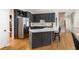 Modern kitchen featuring sleek gray cabinetry, stainless steel appliances, and a spacious island with breakfast bar seating at 3157 Sawyer Ne Ct, Marietta, GA 30066