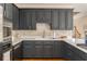 Modern kitchen featuring sleek gray cabinetry, stainless steel appliances, and quartz countertops at 3157 Sawyer Ne Ct, Marietta, GA 30066
