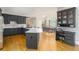 Modern kitchen featuring sleek gray cabinetry, stainless steel appliances, a spacious island, and a dining area at 3157 Sawyer Ne Ct, Marietta, GA 30066