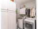 Laundry room with white cabinetry, appliances, and tiled floor at 3157 Sawyer Ne Ct, Marietta, GA 30066