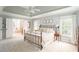 Spacious main bedroom with tray ceiling, carpet, windows, and ensuite bath at 3157 Sawyer Ne Ct, Marietta, GA 30066