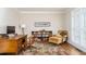 Well-lit home office with wood desk, ample shelving, and a comfortable chair with ottoman at 3157 Sawyer Ne Ct, Marietta, GA 30066