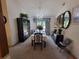 Formal dining room with chandelier, black dining set, china cabinet, and backyard view at 3723 Raiders Ridge Dr, Lithonia, GA 30038