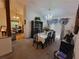 Formal dining room with chandelier, black dining set, china cabinet, and backyard view at 3723 Raiders Ridge Dr, Lithonia, GA 30038