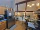 Kitchen with stainless steel refrigerator and appliances, table for two, and view into living room at 3723 Raiders Ridge Dr, Lithonia, GA 30038