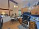 Eat in kitchen with table set for two, stainless steel oven, and view into dining room at 3723 Raiders Ridge Dr, Lithonia, GA 30038