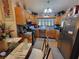 Eat-in kitchen with stainless steel refrigerator, wood cabinets, and view into dining area at 3723 Raiders Ridge Dr, Lithonia, GA 30038