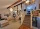 Open concept living room with staircase, chandelier, and view of kitchen through a mirrored beam at 3723 Raiders Ridge Dr, Lithonia, GA 30038
