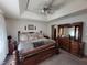 Large bedroom with bed, dresser, carpeted floor and tray ceiling with fan at 3723 Raiders Ridge Dr, Lithonia, GA 30038