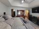View of tray ceiling in main bedroom with large comfortable bed and closet at 3723 Raiders Ridge Dr, Lithonia, GA 30038