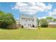 A spacious backyard featuring a well-maintained lawn, stone patio, and wooden privacy fence at 5512 Village Rdg, Fairburn, GA 30213