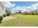 Expansive fenced backyard with stone patio and well-maintained lawn, great for entertaining at 5512 Village Rdg, Fairburn, GA 30213