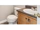 Cozy bathroom featuring a toilet, sink, vanity with granite countertop, and a decorative doorknob at 5512 Village Rdg, Fairburn, GA 30213