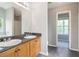 Bathroom featuring double sinks, wooden cabinets, and a large mirror at 5512 Village Rdg, Fairburn, GA 30213