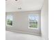 Bright bedroom featuring two windows for natural light with neutral walls and plush carpeting at 5512 Village Rdg, Fairburn, GA 30213