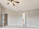 Carpeted bedroom with natural light coming from several windows, with an open doorway to an adjacent room at 5512 Village Rdg, Fairburn, GA 30213