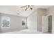 Vaulted ceiling bedroom with a ceiling fan and multiple windows offering natural light and airflow at 5512 Village Rdg, Fairburn, GA 30213