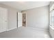 Bedroom features a window, light gray walls, and light gray carpeting at 5512 Village Rdg, Fairburn, GA 30213