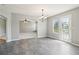 Charming dining room with a chandelier and an open archway to the living area, connecting spaces seamlessly at 5512 Village Rdg, Fairburn, GA 30213