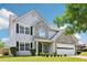 Charming two-story home boasts stone accents, manicured lawn, and attached two car garage at 5512 Village Rdg, Fairburn, GA 30213