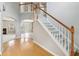 Bright foyer with hardwood floors, staircase, and view into the living room and dining room at 5512 Village Rdg, Fairburn, GA 30213
