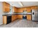Well-equipped kitchen featuring abundant cabinetry, black appliances, and a stainless steel refrigerator at 5512 Village Rdg, Fairburn, GA 30213