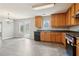 Spacious kitchen with wood cabinets, updated appliances, and a grey tiled floor providing modern appeal at 5512 Village Rdg, Fairburn, GA 30213