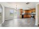 Well-lit kitchen featuring wooden cabinets, black appliances, and a view of the backyard through a glass door at 5512 Village Rdg, Fairburn, GA 30213