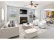 Comfortable living room with a fireplace, and views into the adjacent kitchen at 5512 Village Rdg, Fairburn, GA 30213