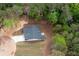 Drone view of house nestled among lush trees, showcasing the layout and privacy at 160 Doris Path, Dallas, GA 30157